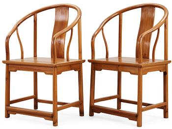 A pair of wooden horseshoeback armchairs, Qing dynasty.