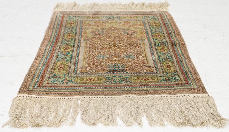 A semi-antique silk Hereke, c. 92 x 61 cm.