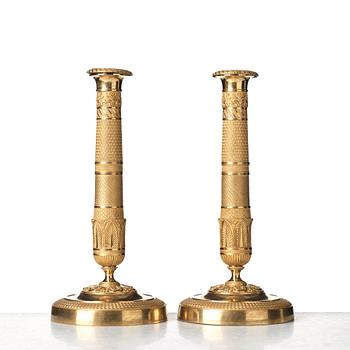 A pair of French Empire early 19th century candlesticks.