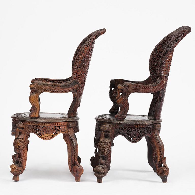 A pair of carved 'blackwood' armchairs, Bombay presidency, British Raj, circa 1880.