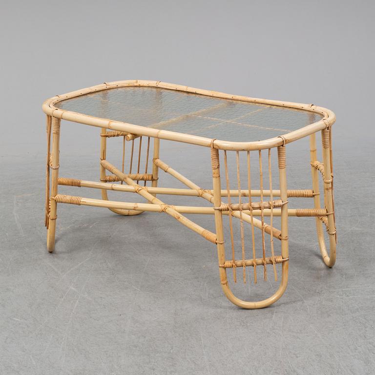 A rattan and glass table and a rattan sofa, second half of the 20th century.