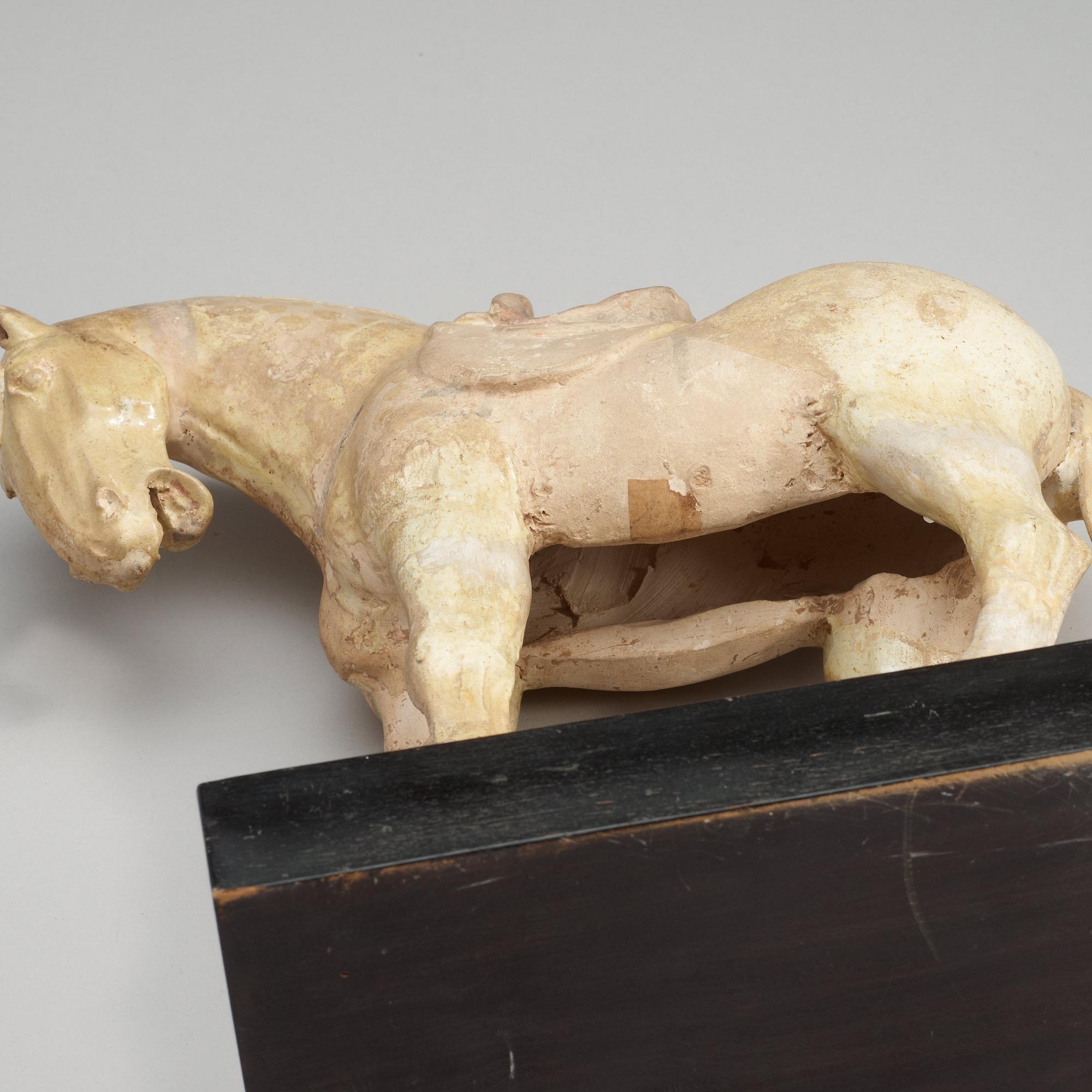 A yellow glazed pottery figure of a horze, presumably Tang dynasty (618-907).