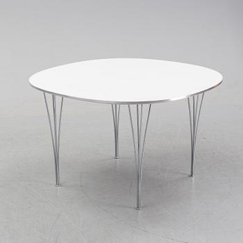 A 'Supercircular' table by Bruno Mathsson & Piet Hein for Fritz Hansen, dated 1985.