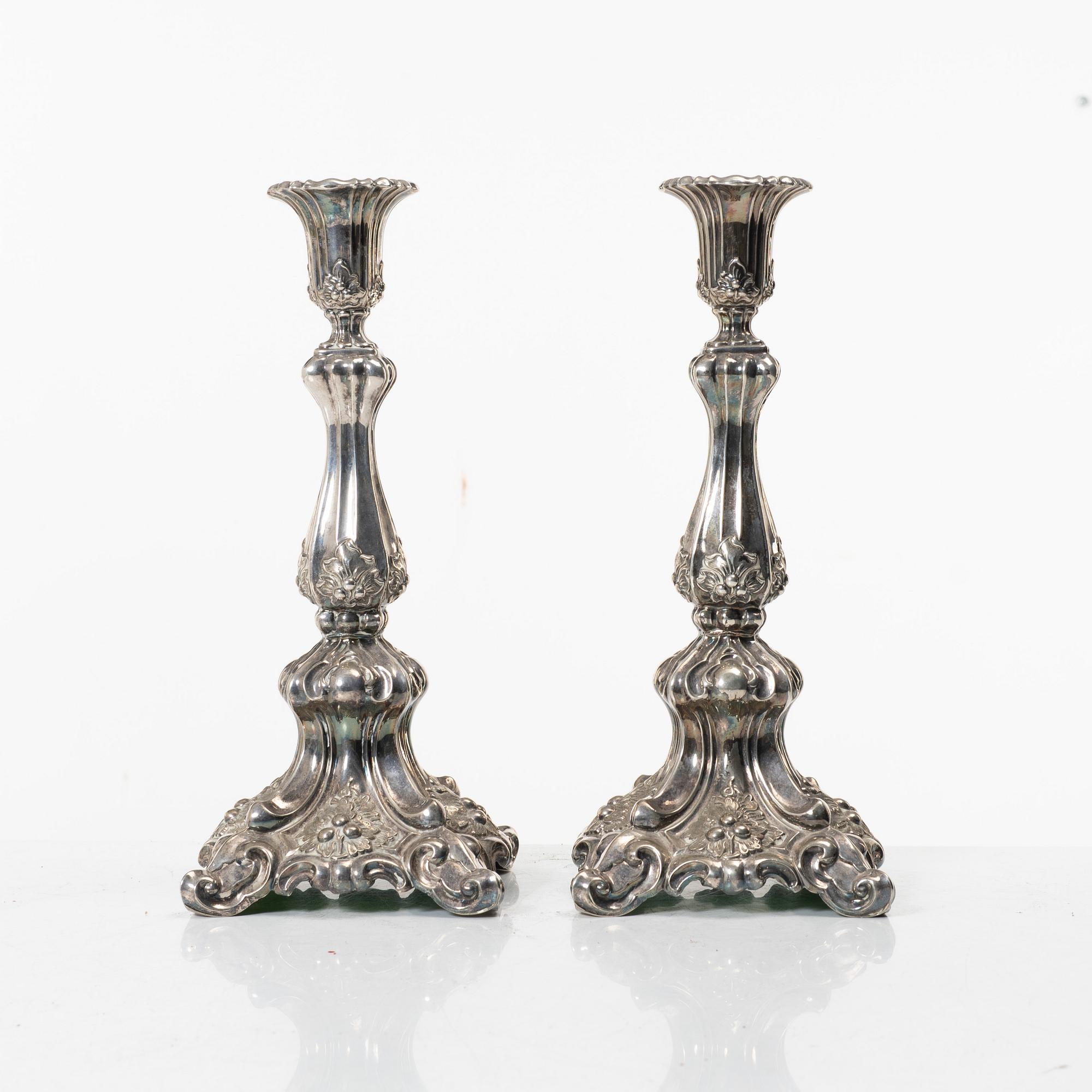 A pair of rococo-style silver candle sticks, early 20th century.