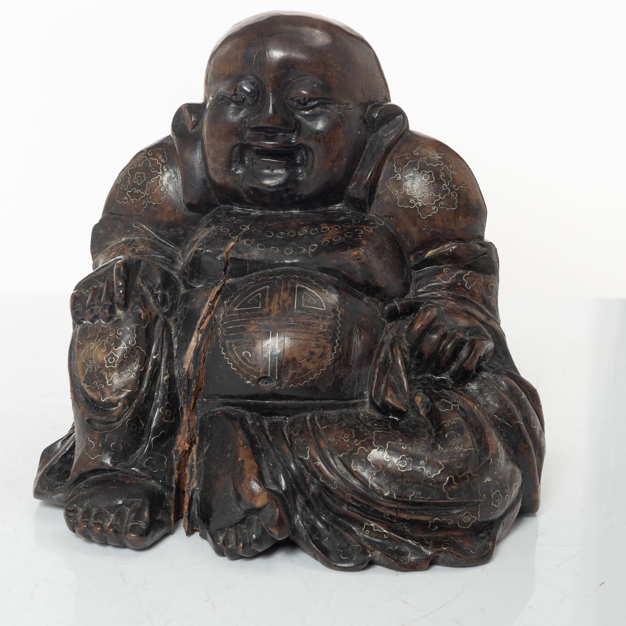 A Chinese wooden figure of Budai with silver inlays, Qing dynasty (1644-1912).