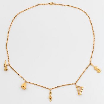 988. An 18K gold  Dior necklace with charms.