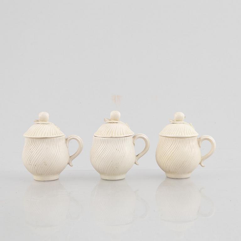 A set of six soft-paste porcelain custard cups with covers, 18th century.