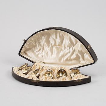 A set of six German parcel-gilt silver 800 salt cellars in fitted case.