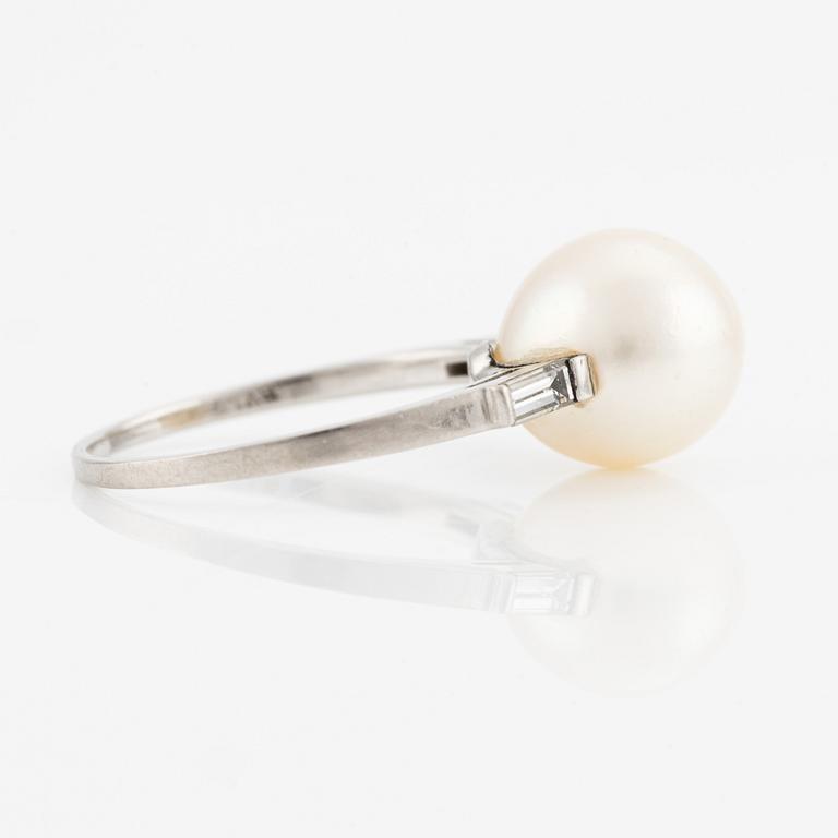 Platinum ring with pearl and baguette-cut diamonds.