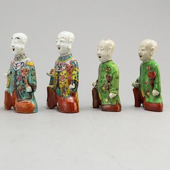 A group of four famille rose figures of laughing boys, late Qing dynasty, 19th Century.