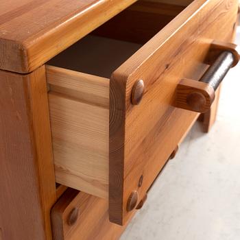 A 1970's set with a pine mirror and chest of drawers.