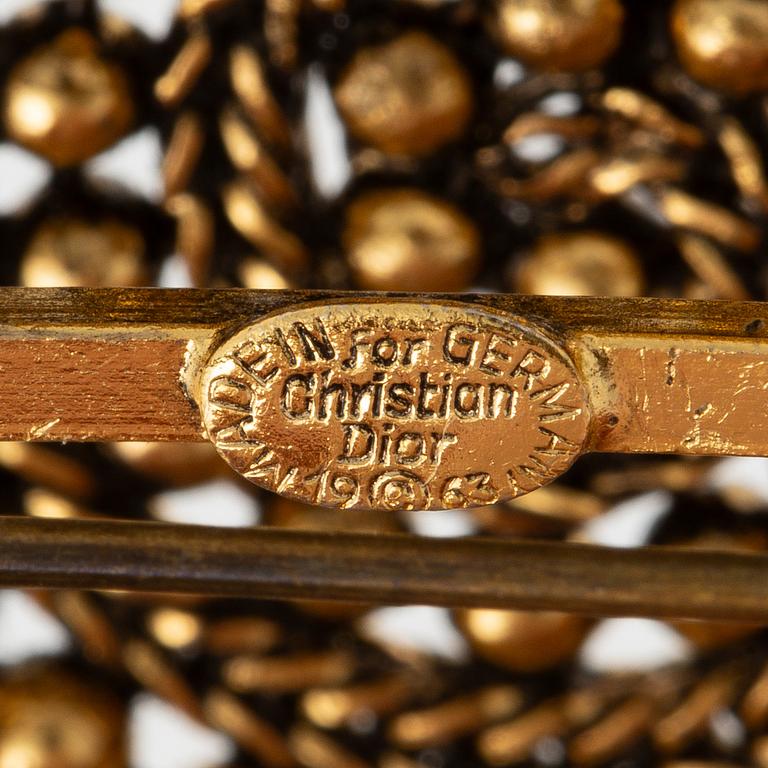 Christian Dior, A gold tone domed vintage brooch, 1963.
