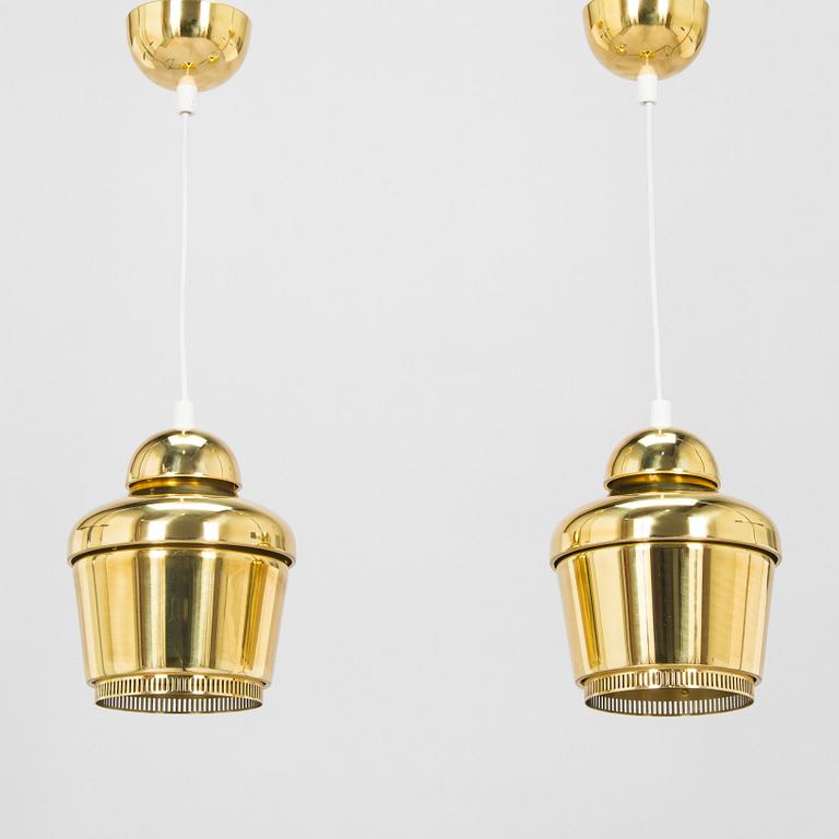 Alvar Aalto, A pair of  A 330, 'Golden Bell' pendant lights A330 for Artek, 2000s.