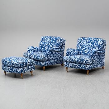 A pair of easy chairs and a stool.