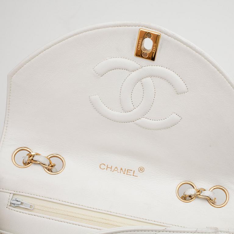 CHANEL, a white leather shoulder bag.