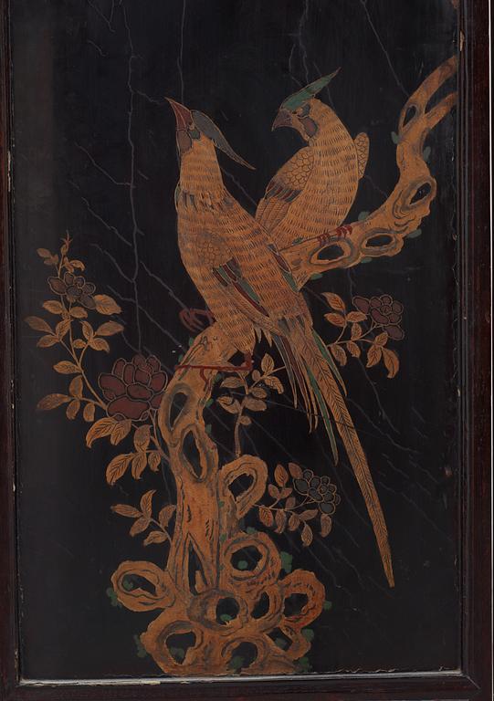 A four panel wooden and lacquered screen with inlays of stone and bone, late Qing dynasty (1912-1644).