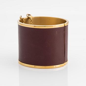 Céline, armring, guldfärgad metall och skinn.