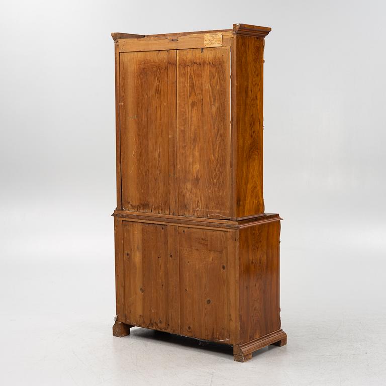 A walnut veneered book cabinet, second part of the 20th Century.