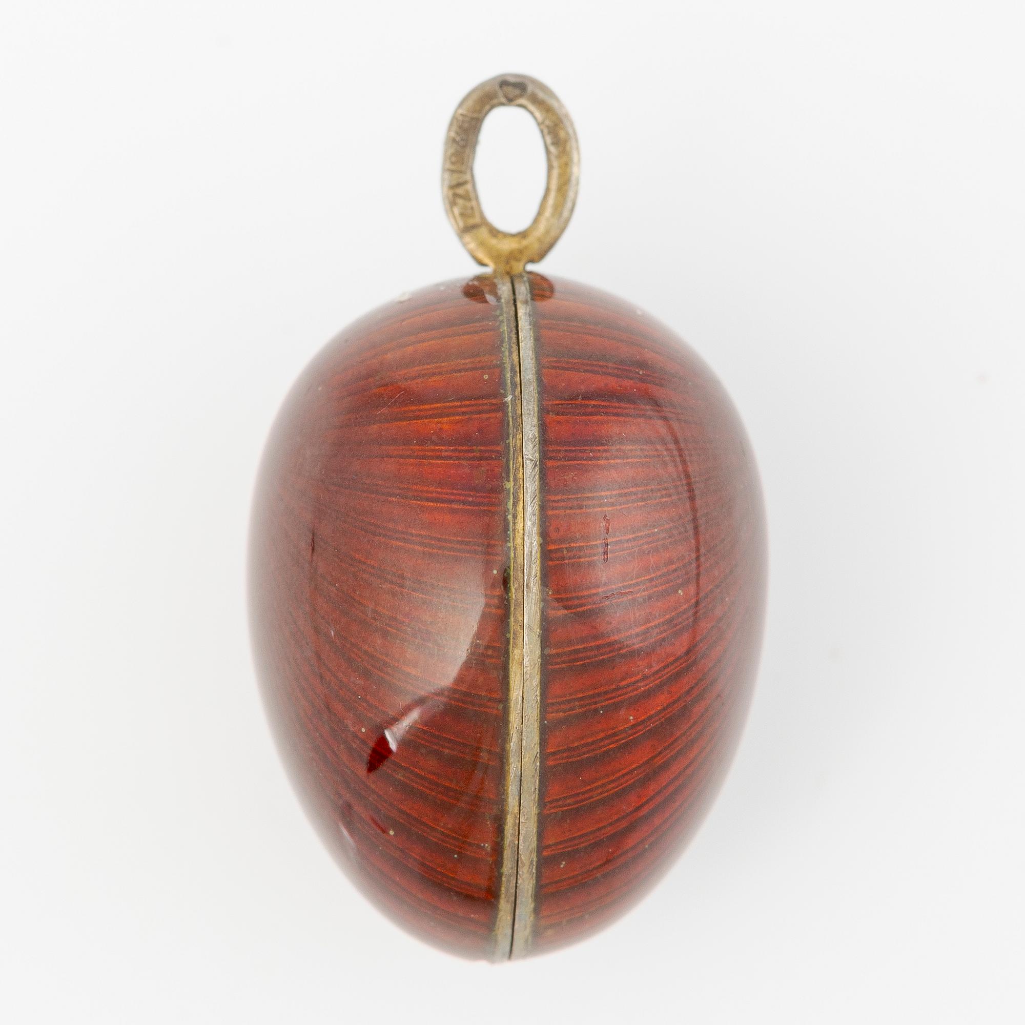 Pendant in the shape of an egg, silver with red enamel.