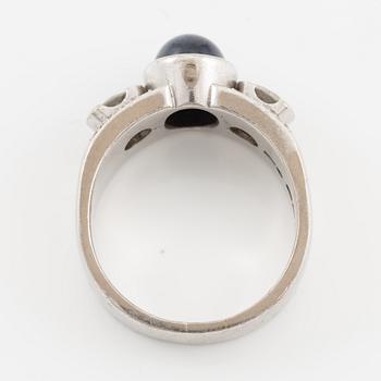 Ring in 18K white gold set with a cabochon-cut sapphire and brilliant-cut diamonds, Kenneth Magnell.