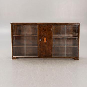 A 1930s birch book cabinet.