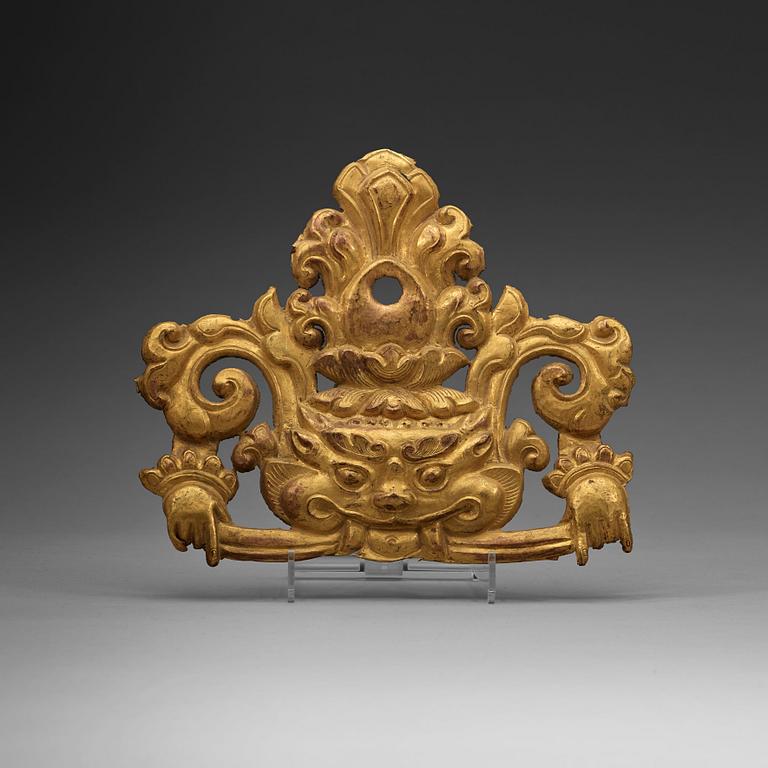 A Tibetan gilt metal ornament, 19th Century.