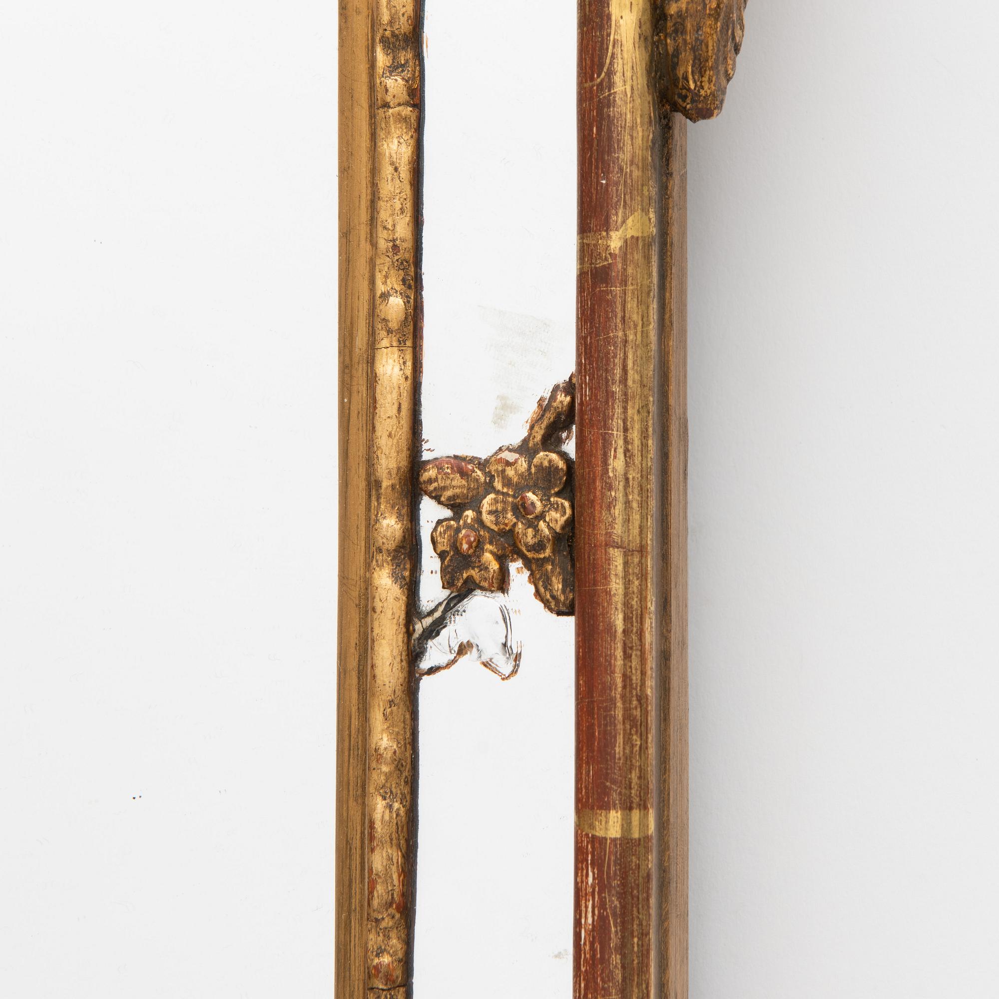 A Rococo style mirror, circa 1900.