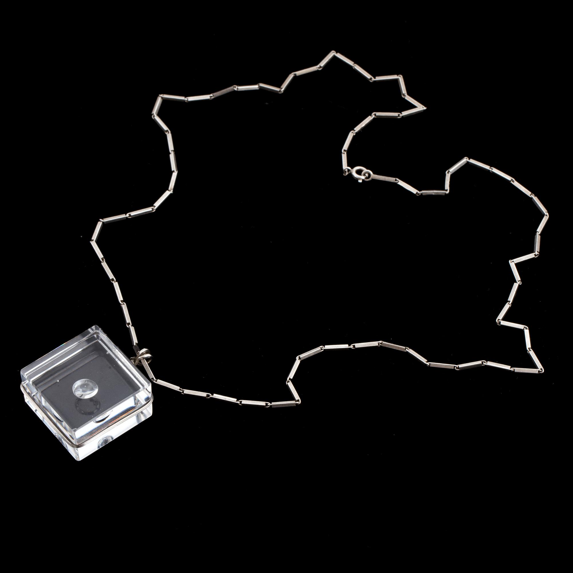 A glass pendant designed by Gunnar Cyrén and a silver necklace.