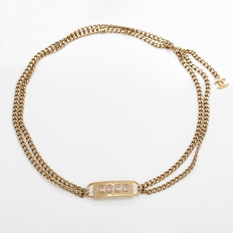 Chanel, A gold coloured metal chain belt with pink stones. Marked "CHANEL 02 CC P MADE IN ITALY".