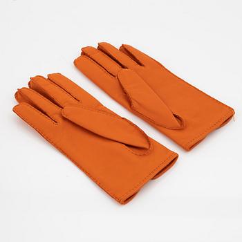 Hermès, a pair of orange kidskin and lambskin gloves, french size 7 1/2.