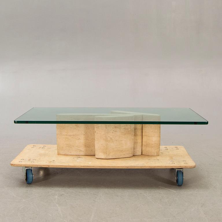 A glass and travertine coffee table later part of the 20th century.