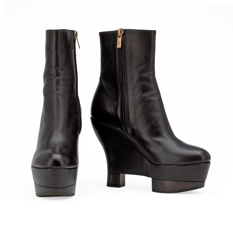 YVES SAINT LAURENT, a pair of brown leather wedge heeled platform boots.