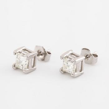 A pair of princess cut diamond earrings.