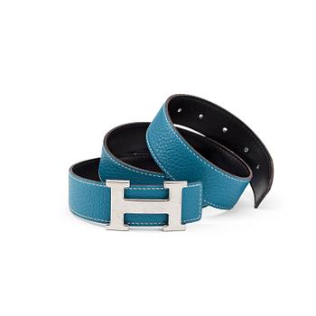 HERMÈS, a reversible belt, blue and brown with silver colored H belt buckle.