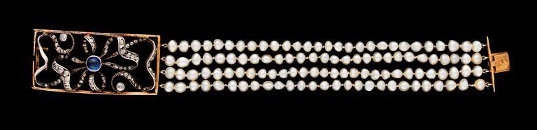 A four strand natural pearl bracelet with diamond and sapphire clasp.