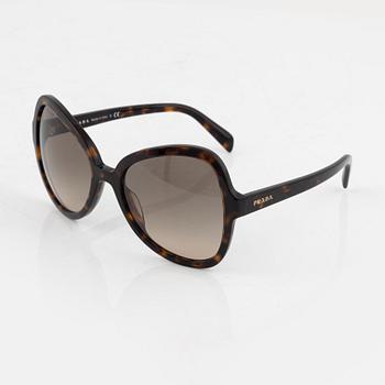 Prada, a pair of tortoise color sunglasses.