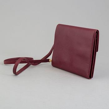 A burgundy leather bag from les must de Cartier.