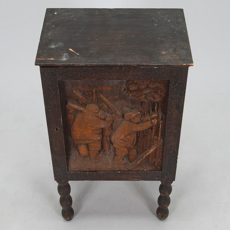 A 1920s cabinet with a relief.