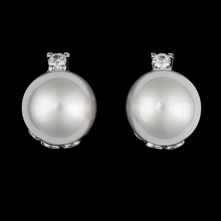 A pair of cultured South sea pearl, 15,2 mm, and brilliant cut diamond earrings, tot. app. 0.35 cts.