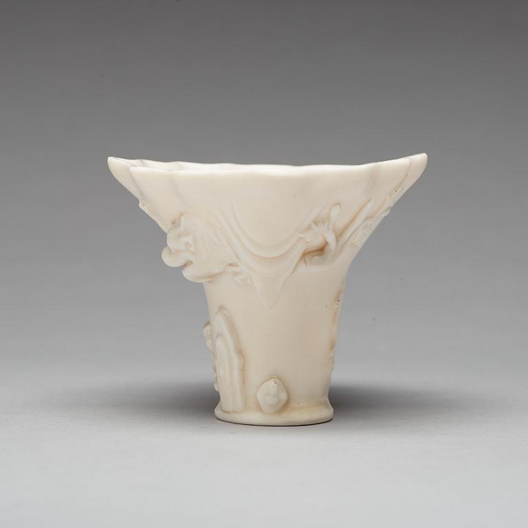 A blanc de chine rhinoserous shaped libation cup, 17th Century.