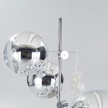 A "Mirror ball tripod floor lamp" from 2015 by Tom Dixon.