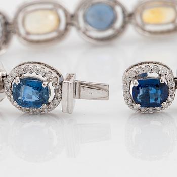 An 18K white gold bracelet set with faceted blue and yellow sapphires with a total weight of 25.80 cts.