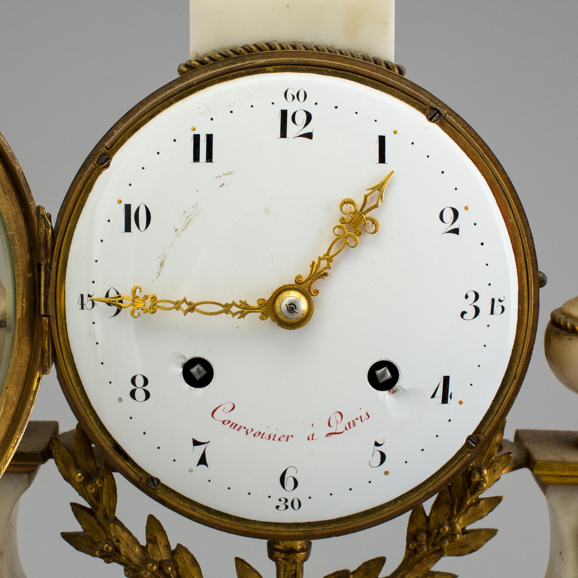 A Louis XVI marble and bronze mantel clock from the second half of the 18th century.