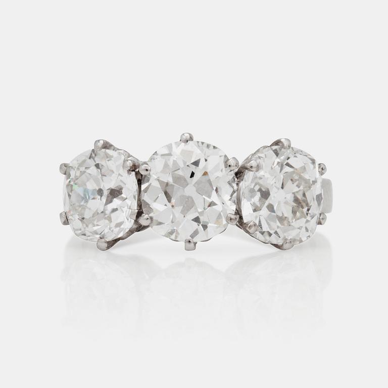 A three stone old mine and old cushion cut diamond ring. Total carat weight 4.01cts.