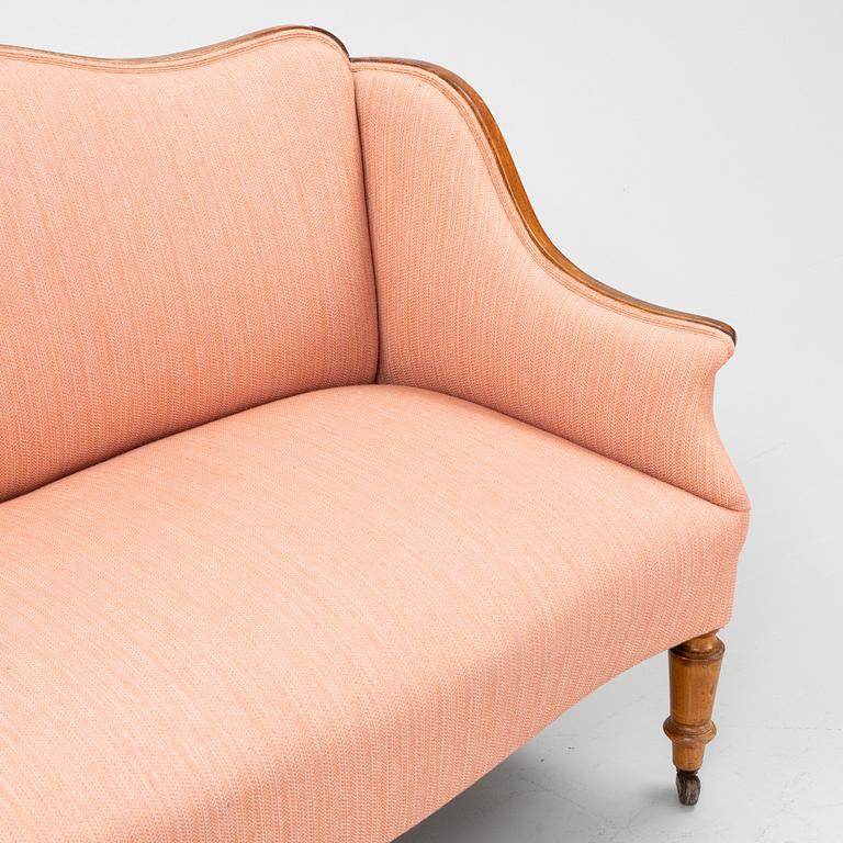 A stained beech sofa, late 19th Century.