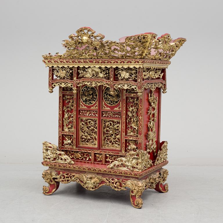 A Chinese red lacqured altar cabinet, late Qing dynasty/early 20th century.