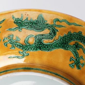 A yellow and green glazed anhua decorated five clawed dragon dish,  Qing dynasty with Jiajing mark.