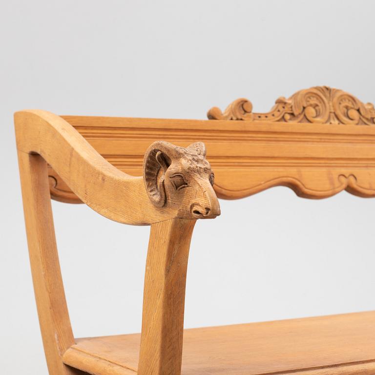 A carved oak sofa, circa 1900.