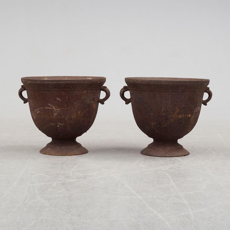 A pair of early 20th century iron garden urns.