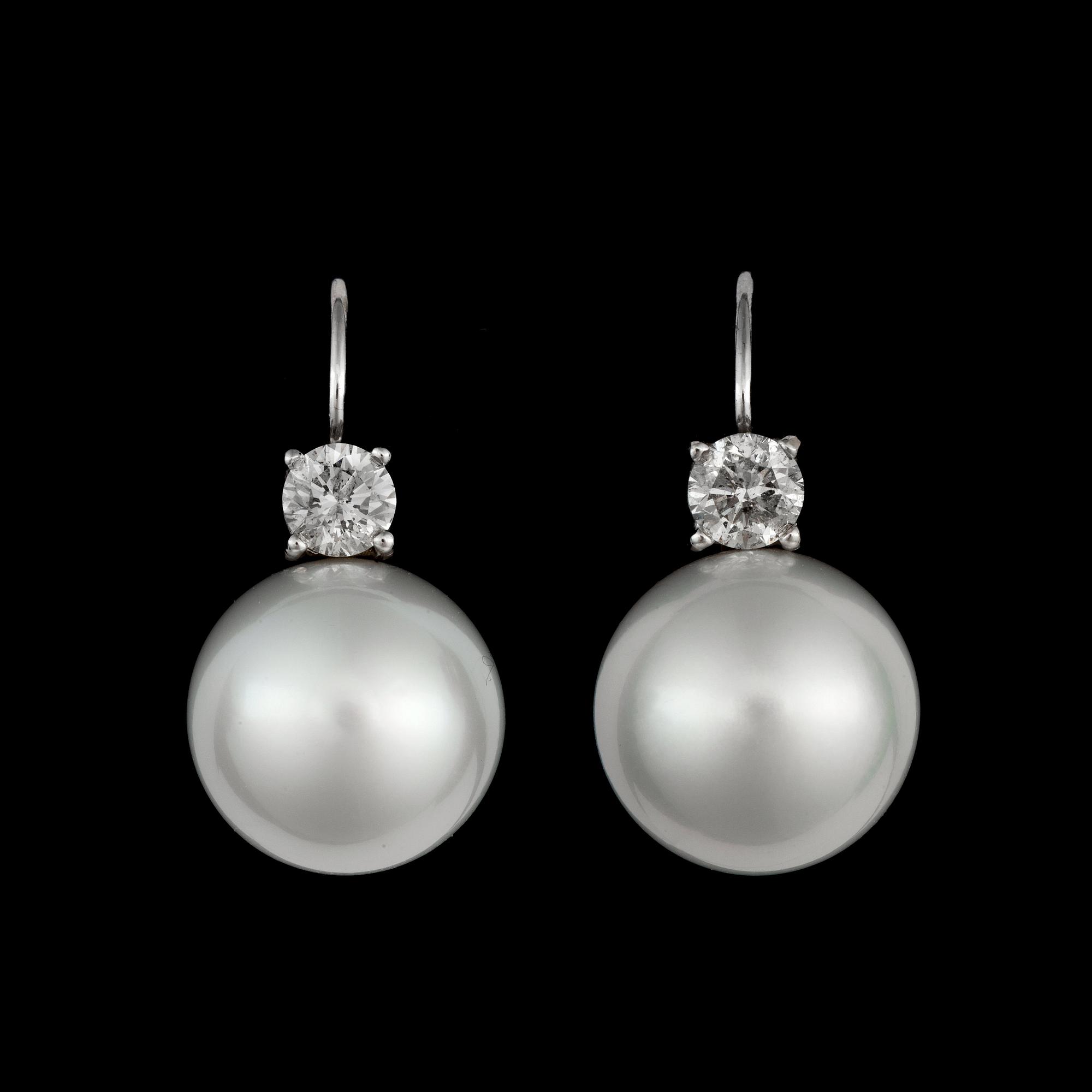 A pair of cultured South sea pearl and diamond earrings. Total carat weight of diamonds circa 1.00 ct.
